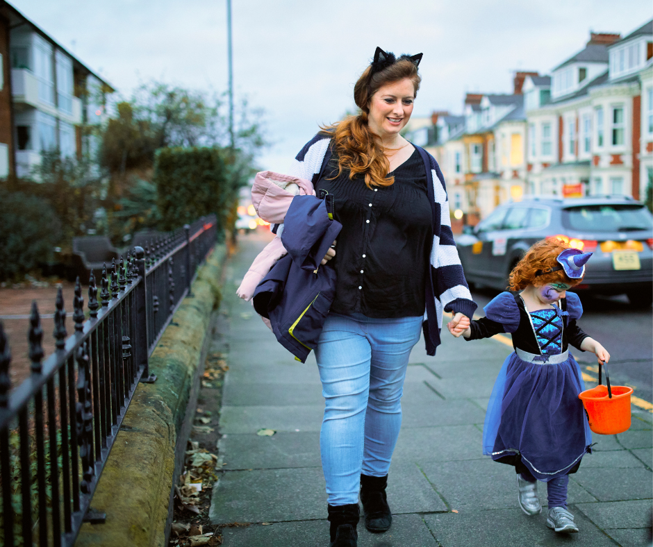 parent taking child trick or treating