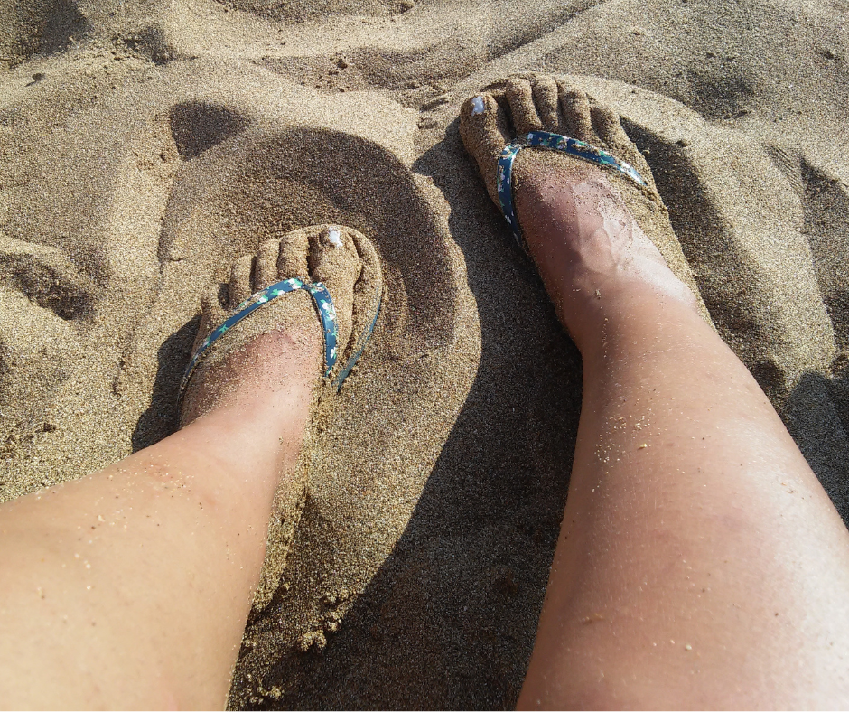 feet in sandals on beach