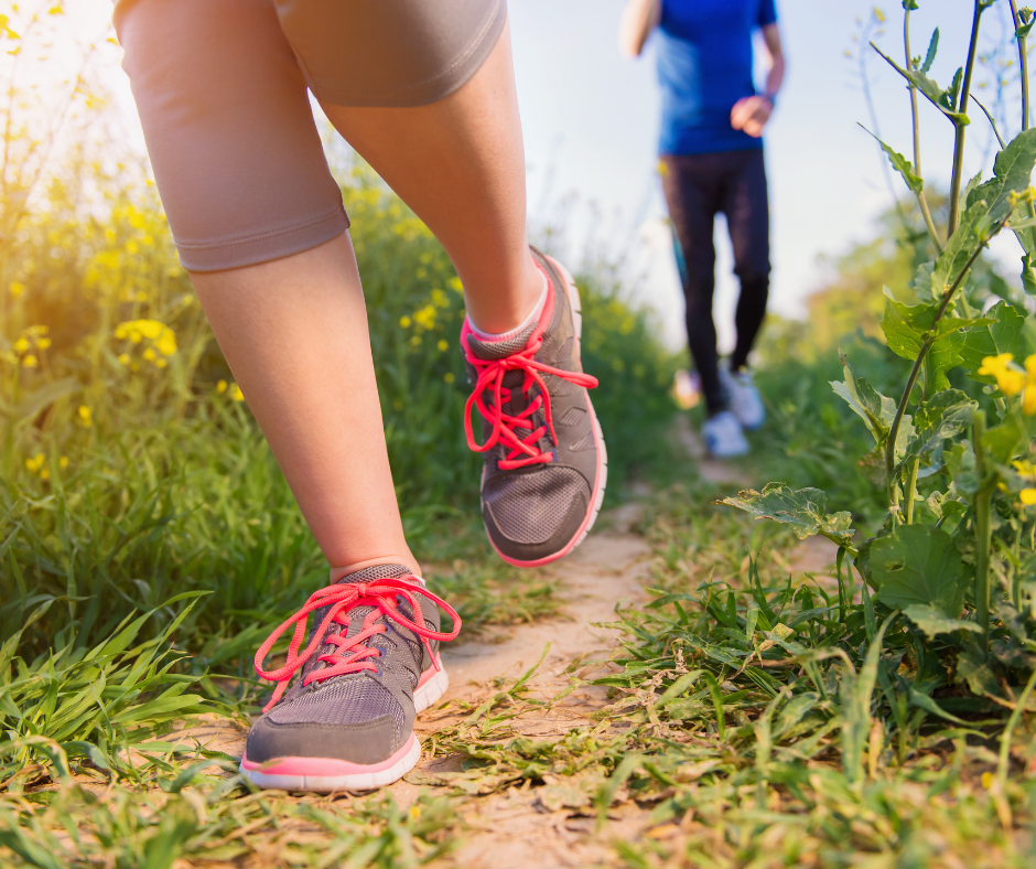 people running on a grassy path