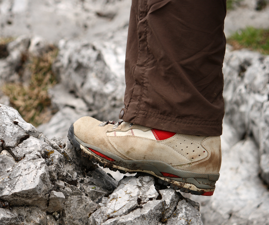 a hiking boot on rocky ground